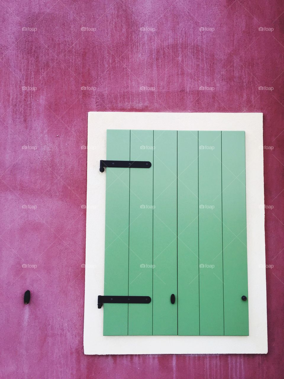 Close window on pink wall