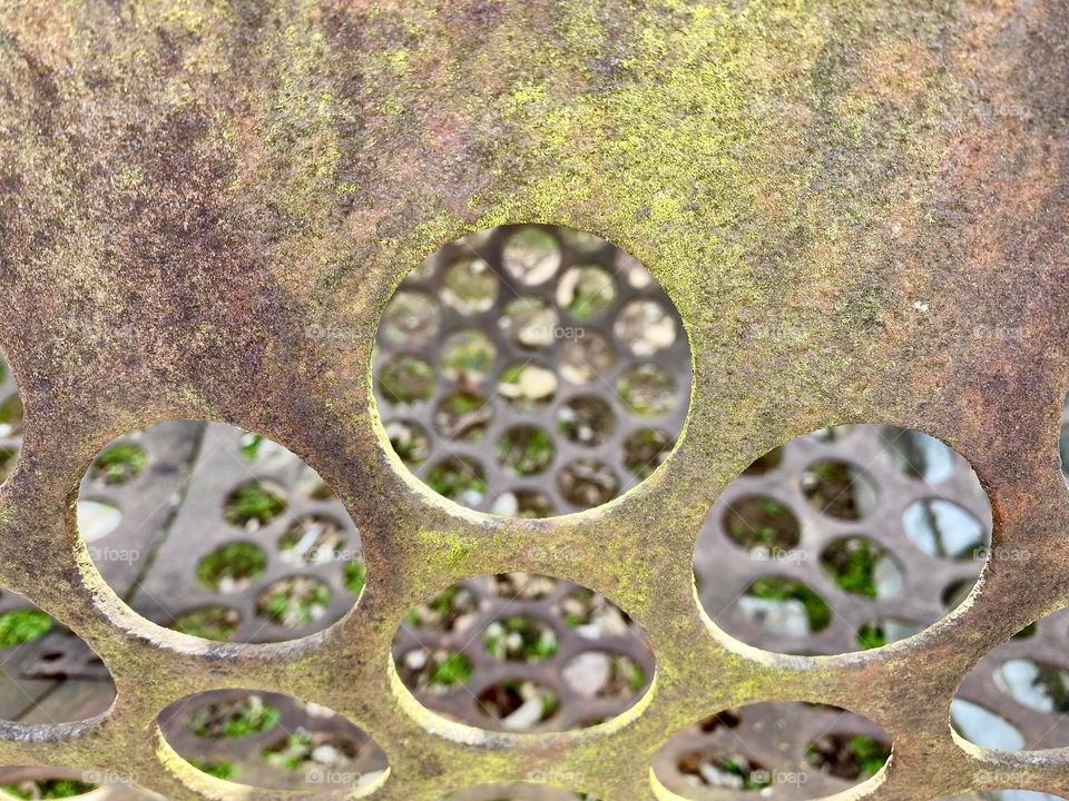 Holes in a metal tube used to sort ore by size