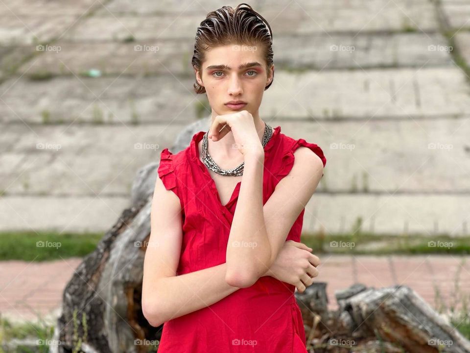 Portrait of beautiful guy in red dress.