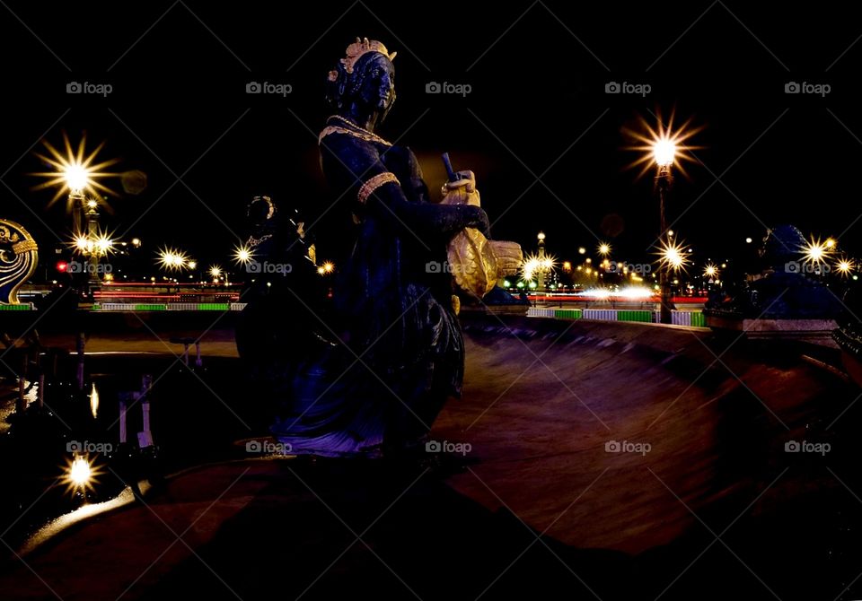 Nighttime photography, city at night, long exposure photography, statue in a fountain, Paris at night