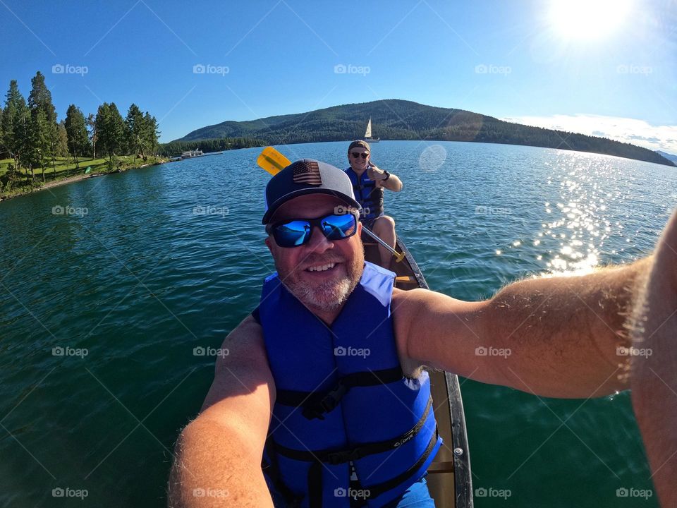 My son and I enjoy a warm summer day by canoeing on a lake