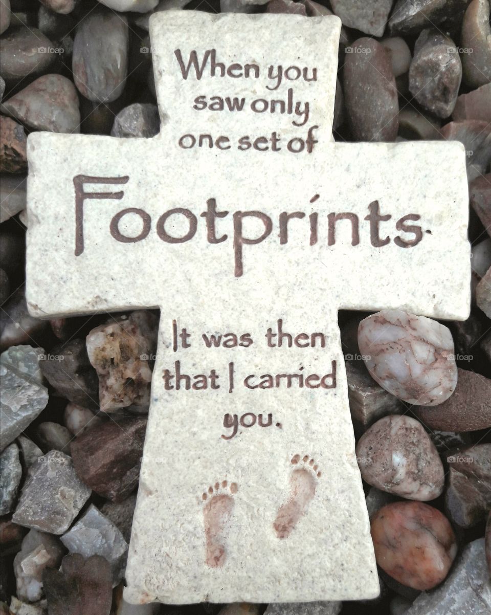 Footprints poem written on a stone cross