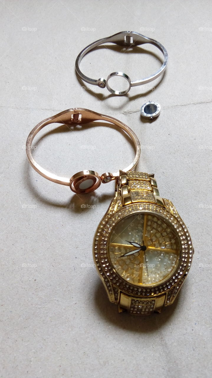 golden wrist watch,  rose gold bracelet and silver bracet