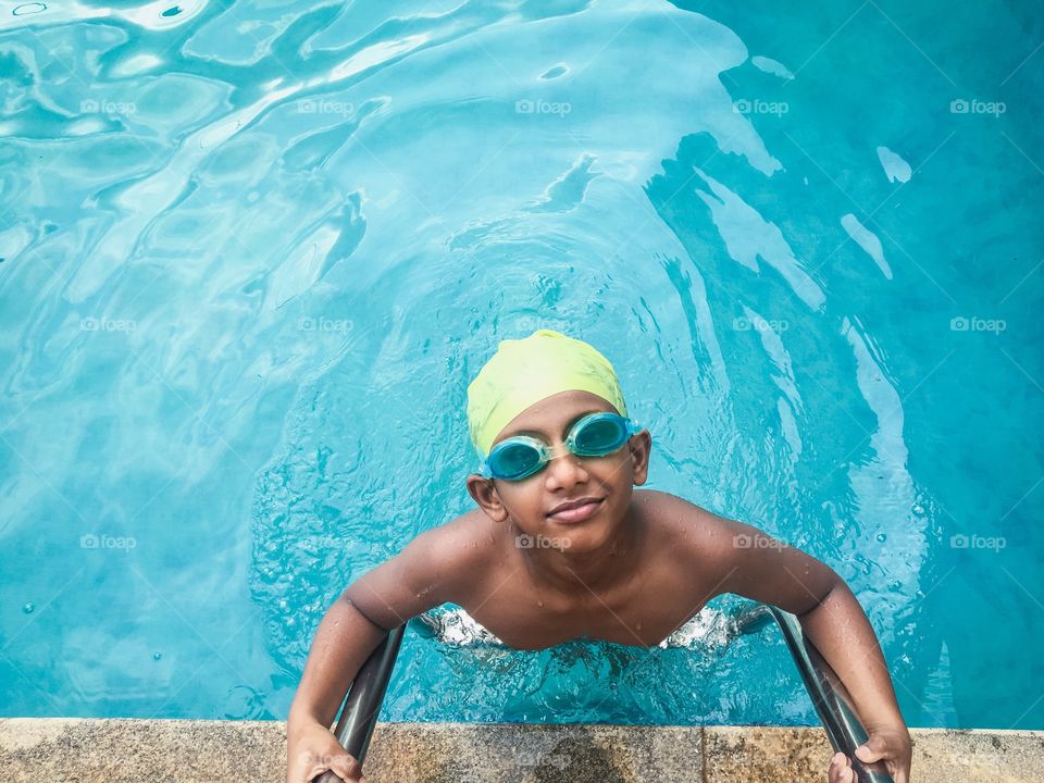 Indian kid coming out of pool