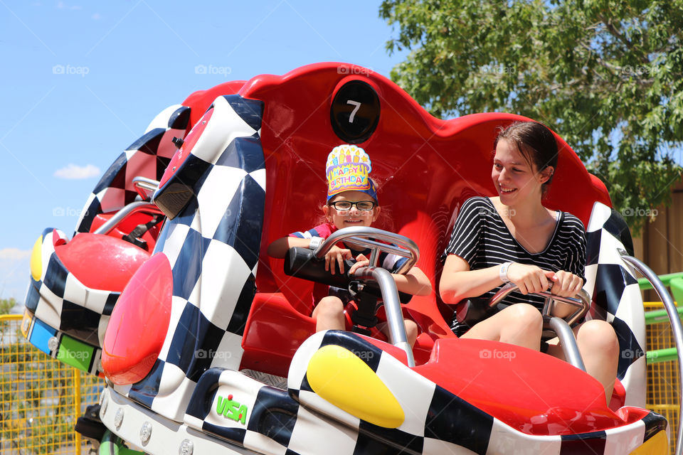 Sisters taking a ride at the theme park