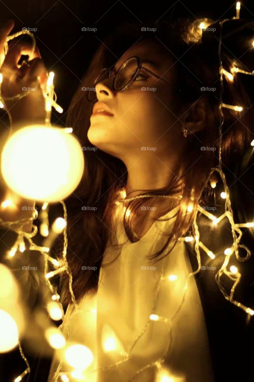 Woman holding illuminated light