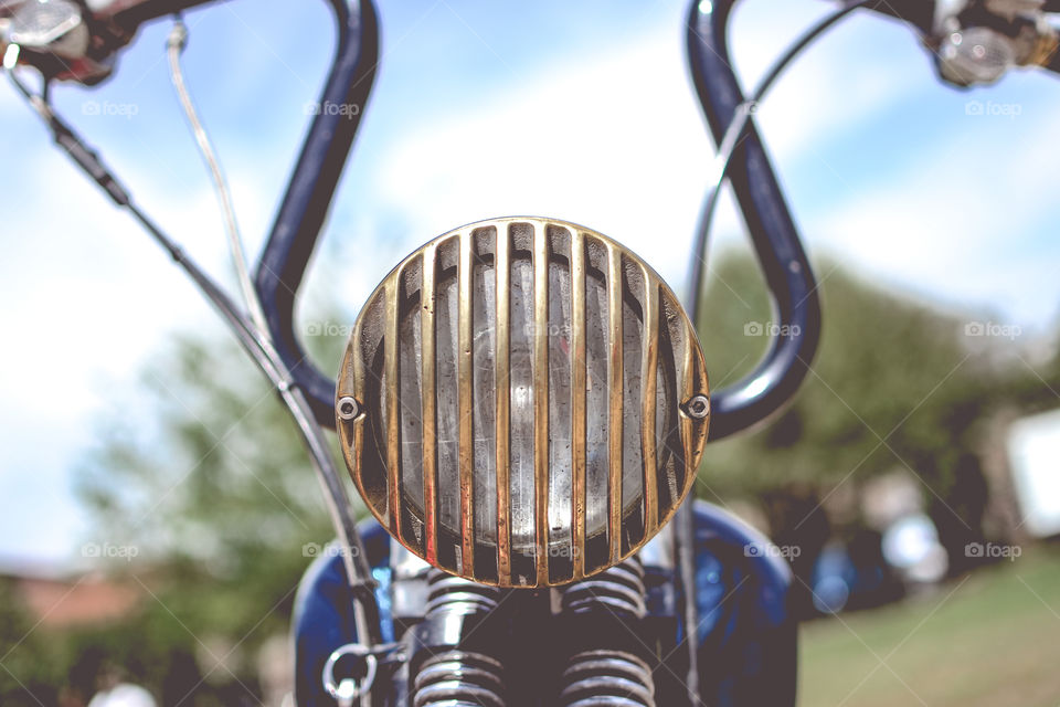 golden and gray old motorcycle headlight