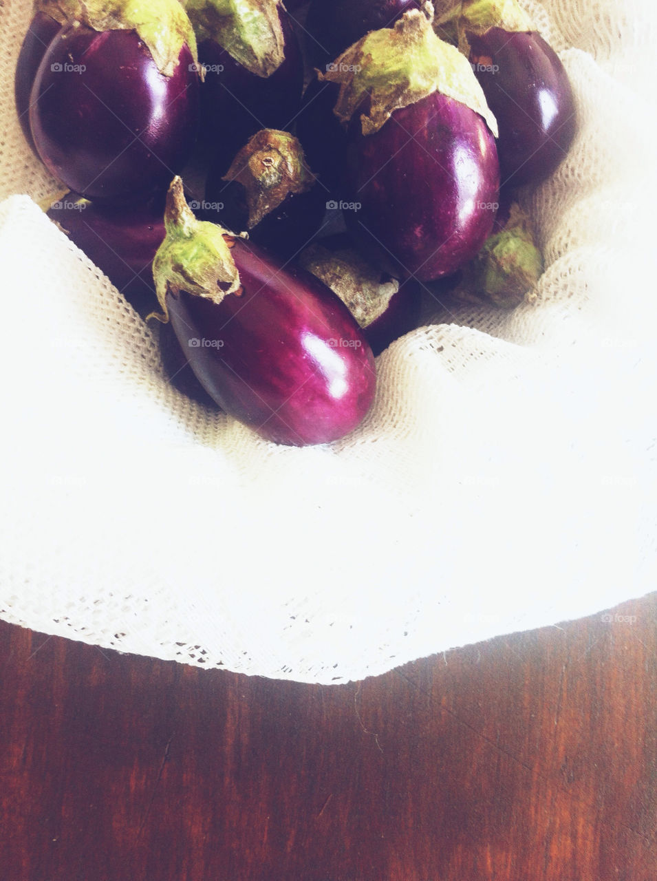 Several eggplant in a basket.