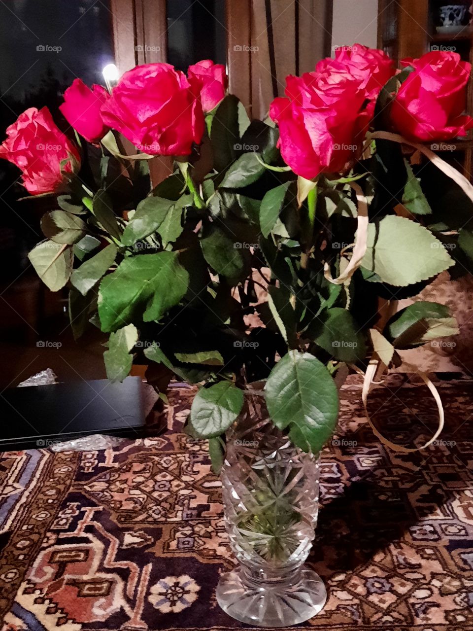 bouquet of red roses in cristal vase on the table