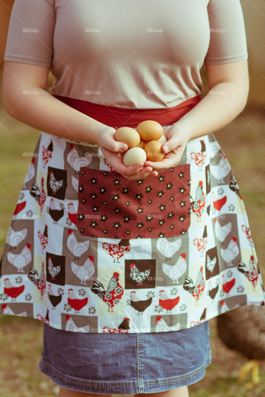 Woman holding egg in her hands