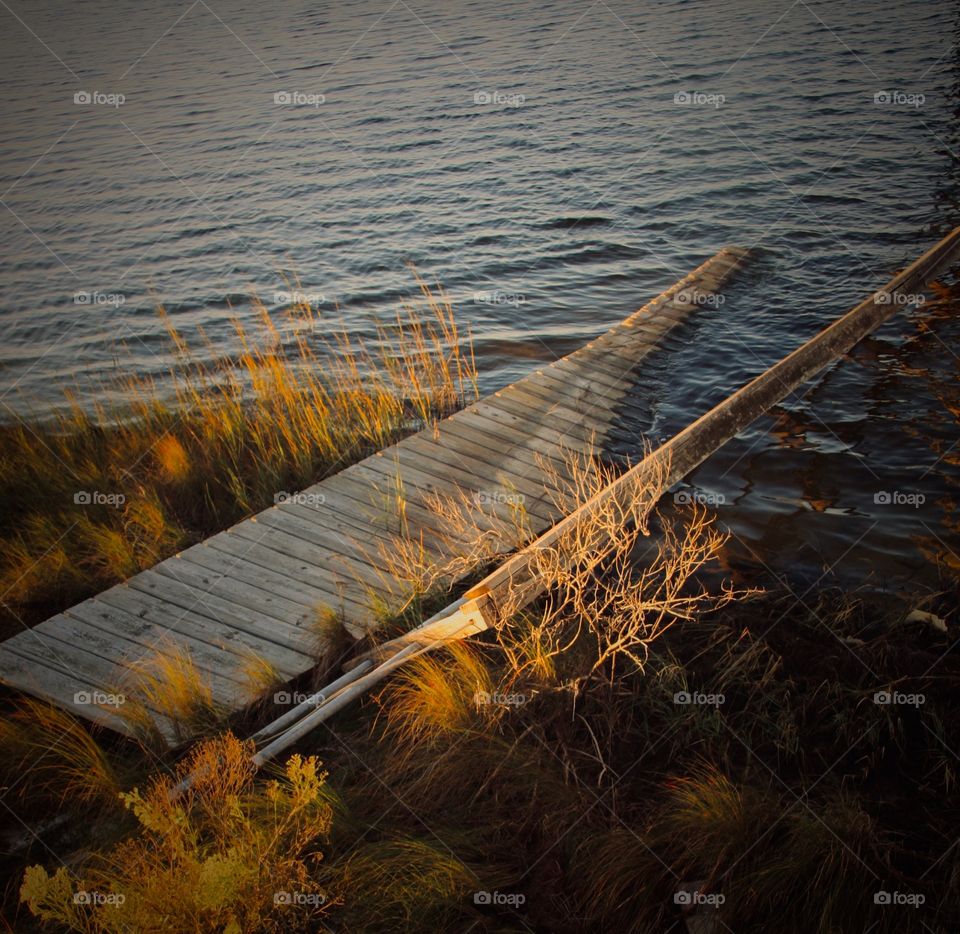 An old dilapidated dock that has collapsed into the water