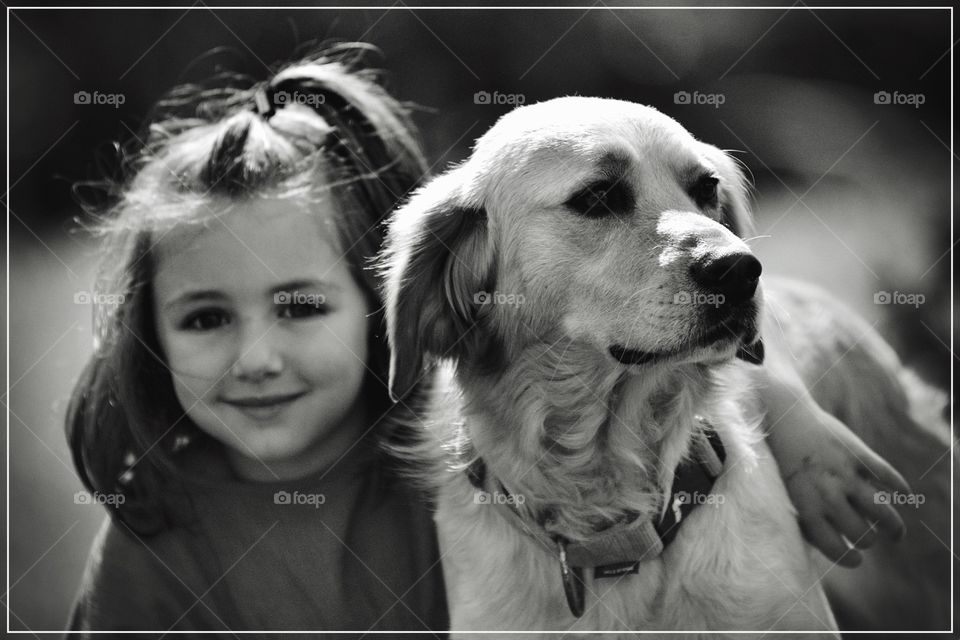 Portrait of a dog with cute little girl