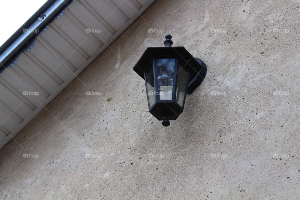 rustic lamppost on house