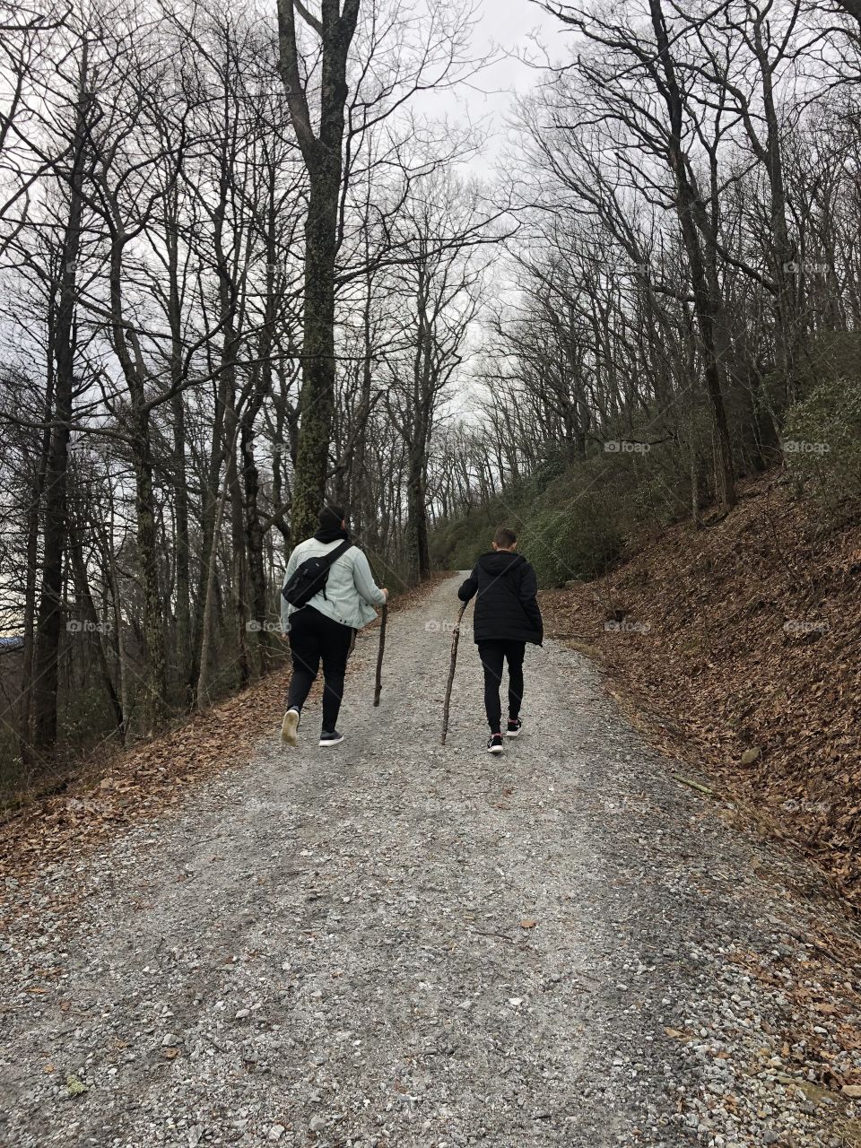 2 boys hiking in the mountains on a fall day