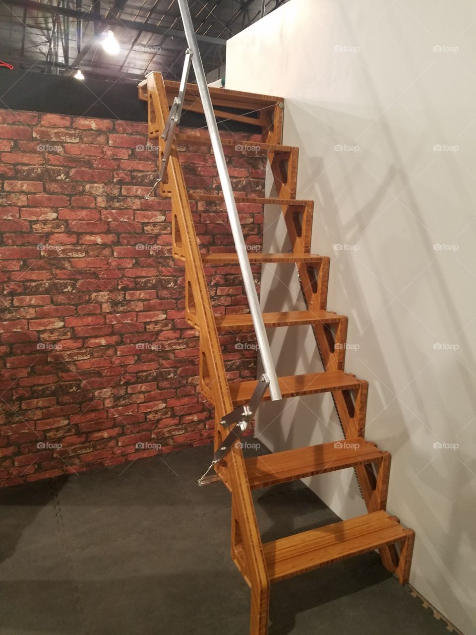 A set of stairs that fold up tight to the wall. They are custom built for the specifications of your space.   Designed for tiny homes.