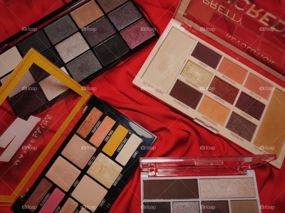 Makeup pallets /Makeup products / Beauty accessories / 4 colourful makeup pallets with red background /Product photography