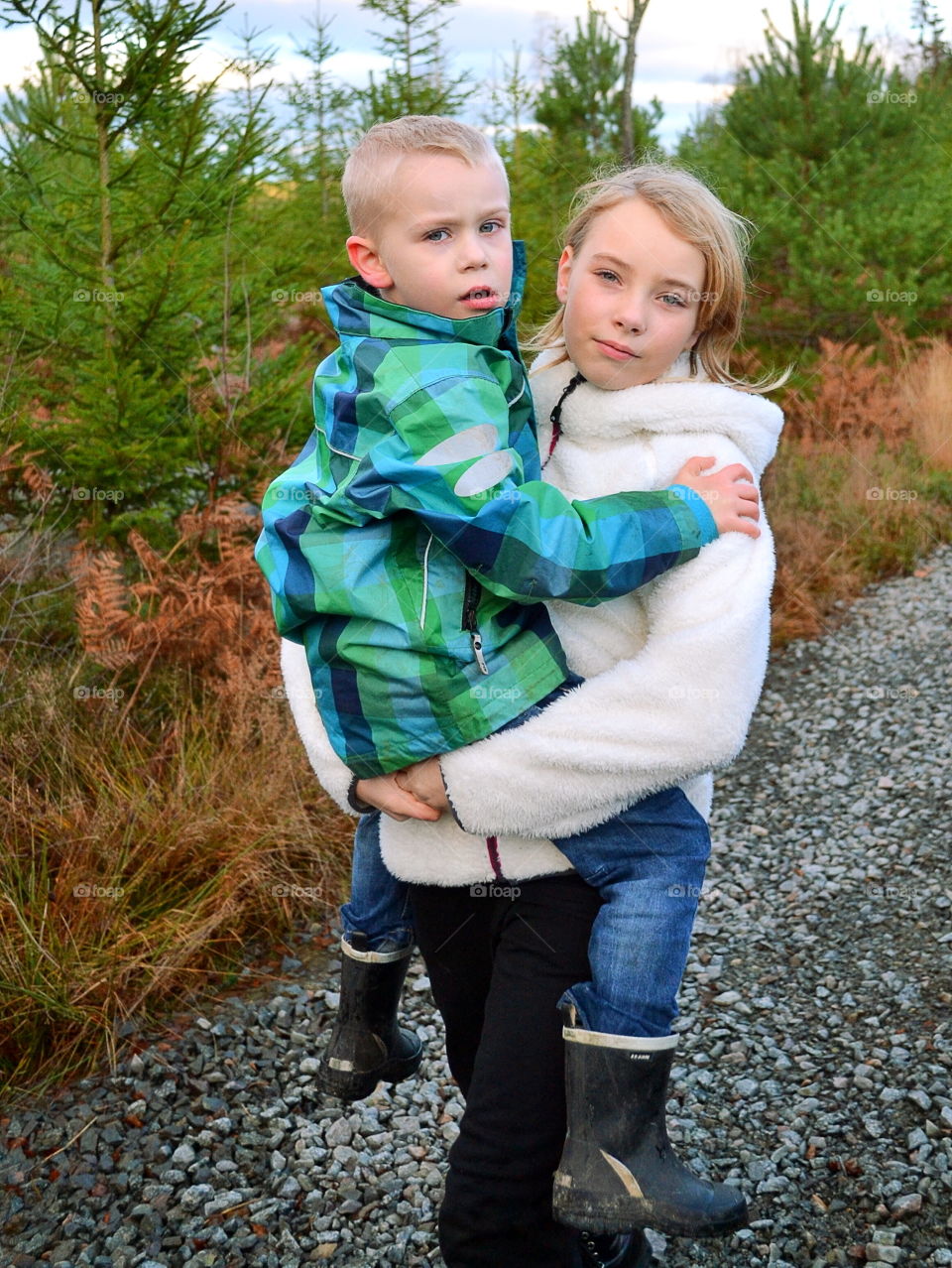 Big sister hugging her little brother