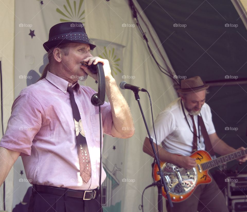 Telephone Tunes. A harmonica playing band leader uses a telephone to get the perfect sound. 