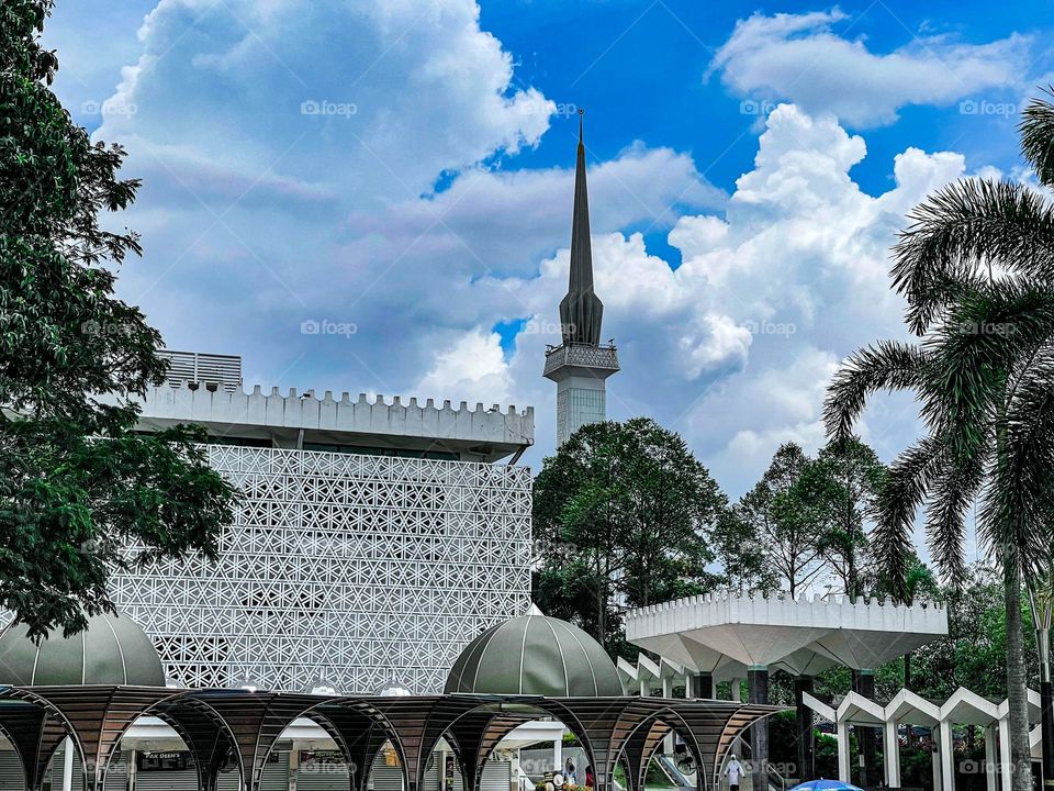 Mosque architecture view from outside with blue cloudy sky as background 