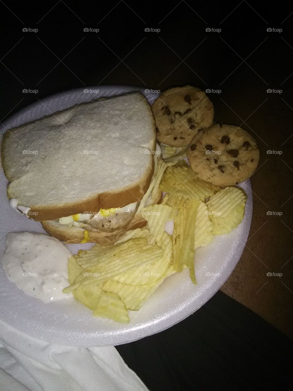another Turkey burger on white bread with chips and chocolate chip cookies