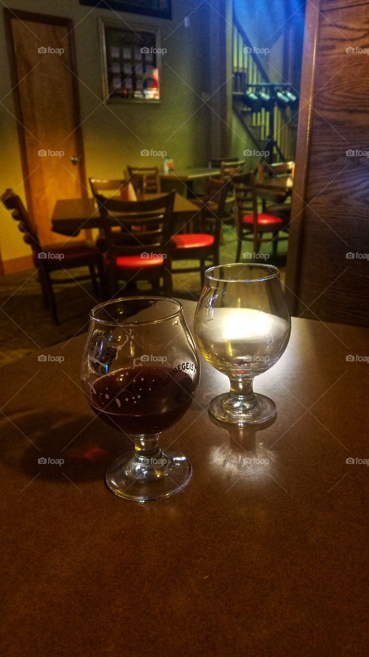 Two glasses in bar.