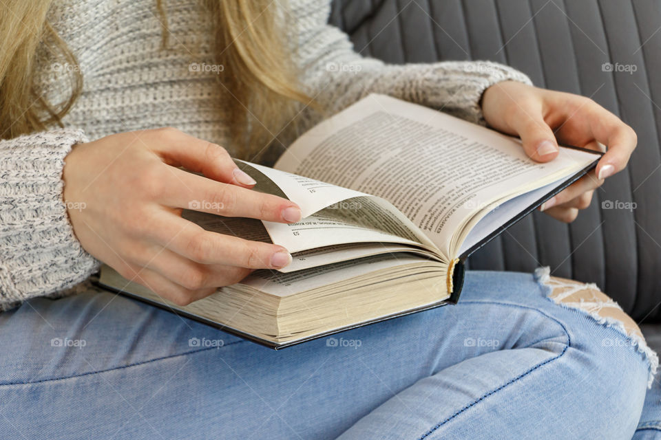 girl sitting on the bed and reading a book