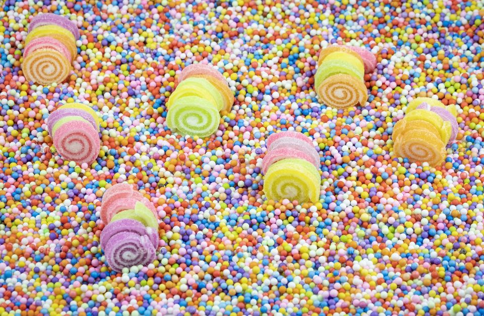 Sugar roll in the colorful field , Confectionery,Sweets,Candy,Lollies,Treats in the colorful background