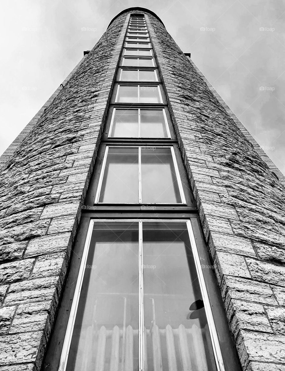 Black and white monochrome high narrow modern building with big windows architecture facade exterior bottom up