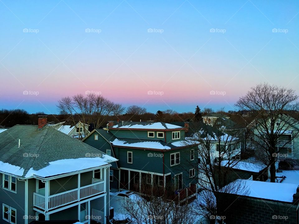 Sunrise over snowy rooftops 