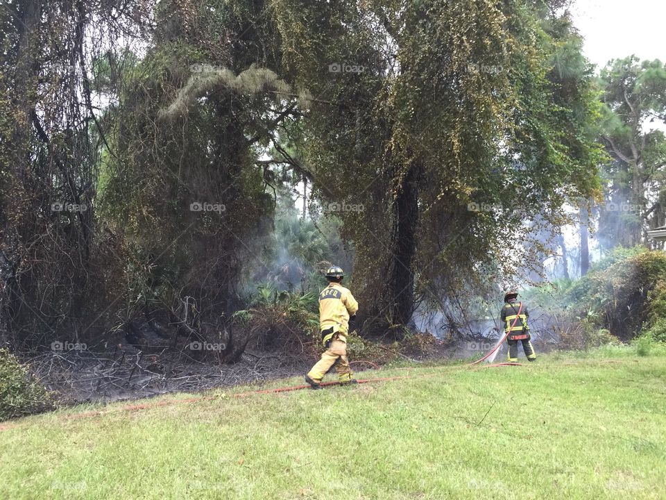 Firefighters putting out blazes.