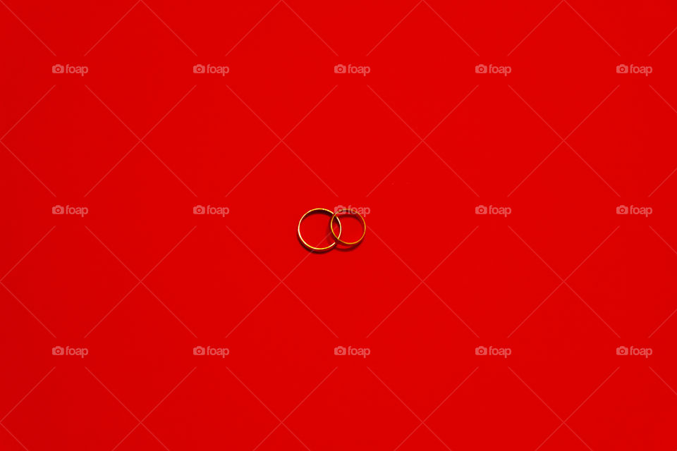 Minimalist - wedding rings on red background