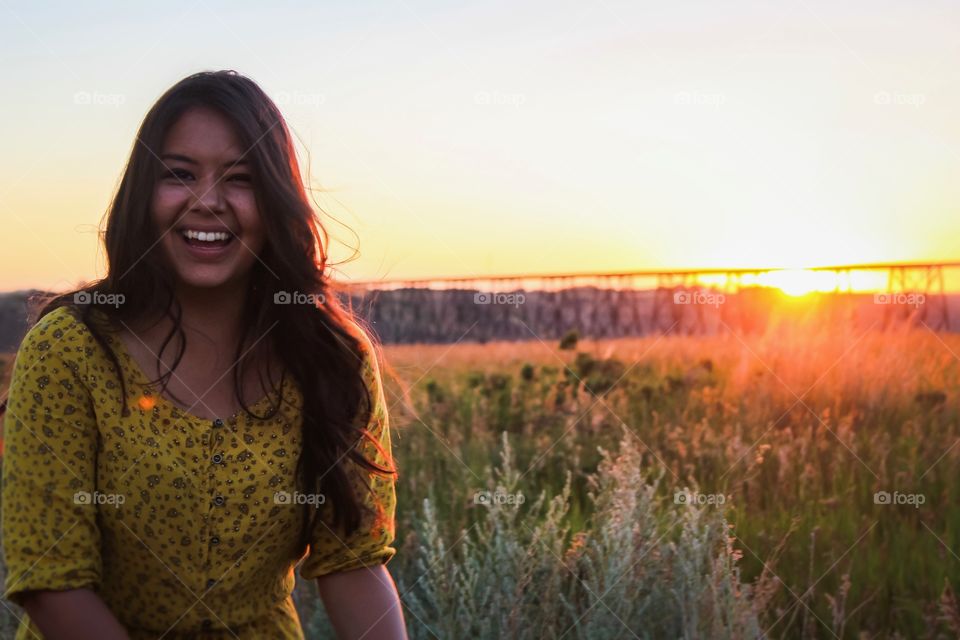 Beautiful girl having fun in the rural sunset glow 