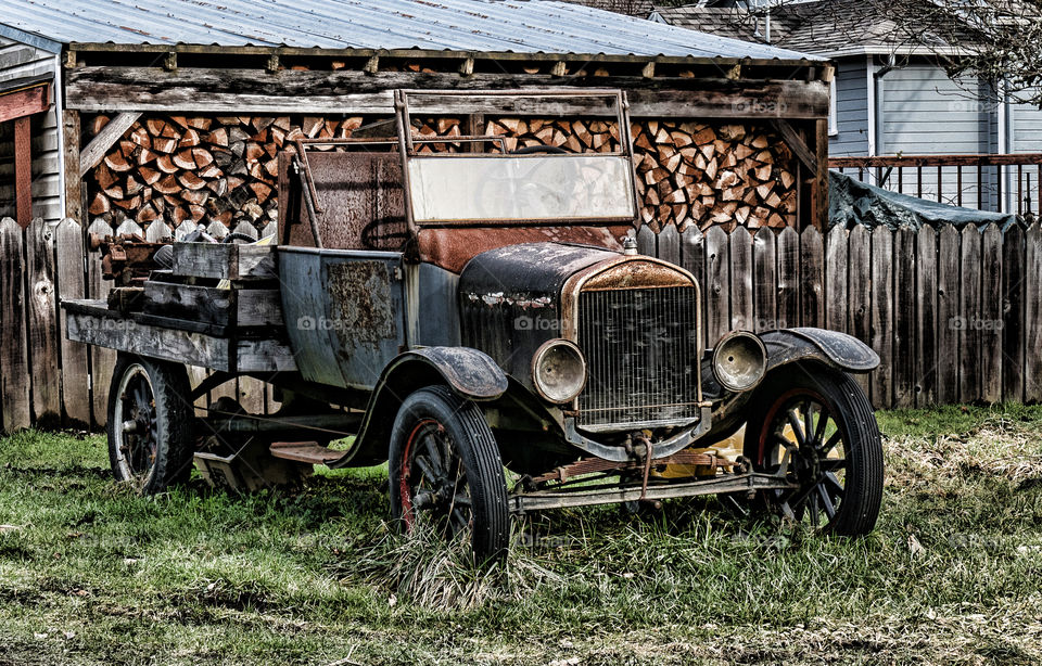 Old pick-up and stack of firewood