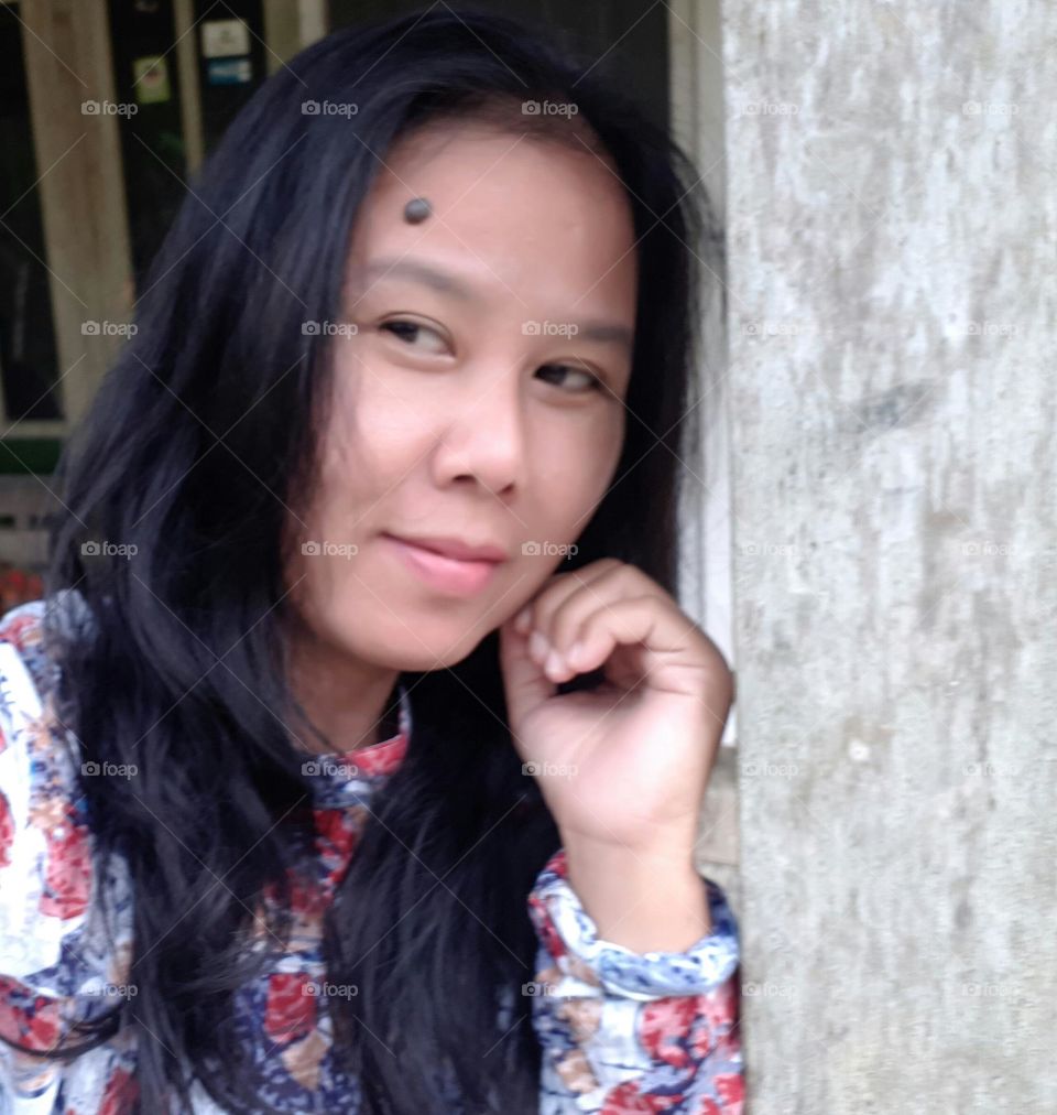 a woman is standing dreamily and smiling happily