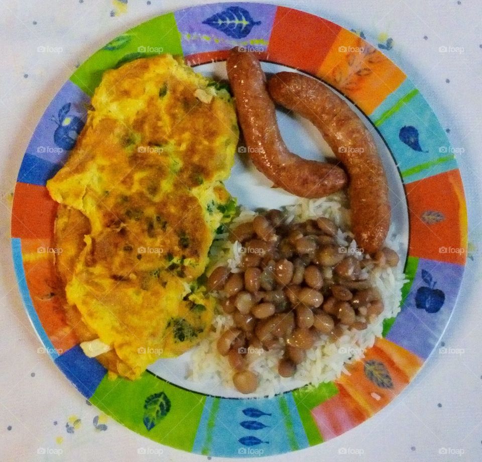 Rice, beans, omelette with cheese and sausage.