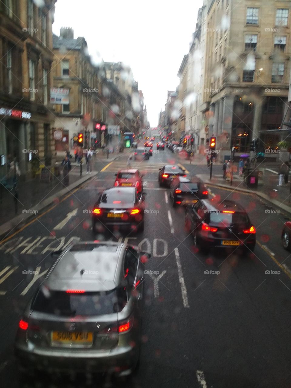 View of a road with cars through a blurry window