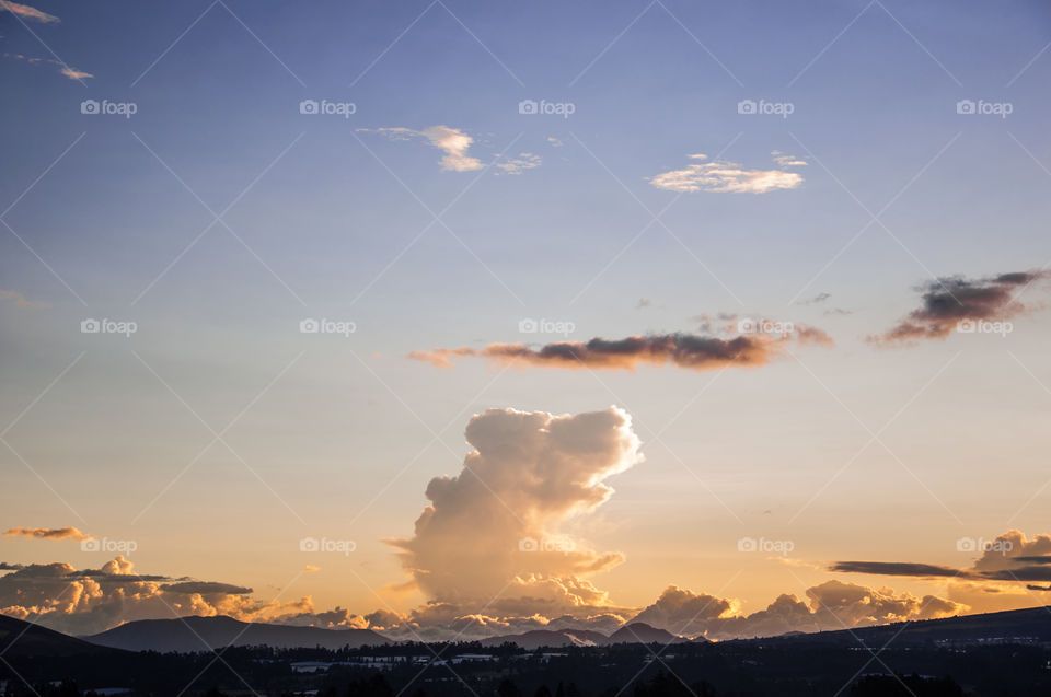 Different types of clouds in a sunset over a valley 