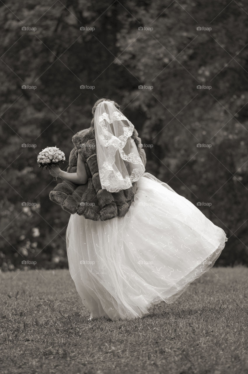 Happy running bride with bouquet