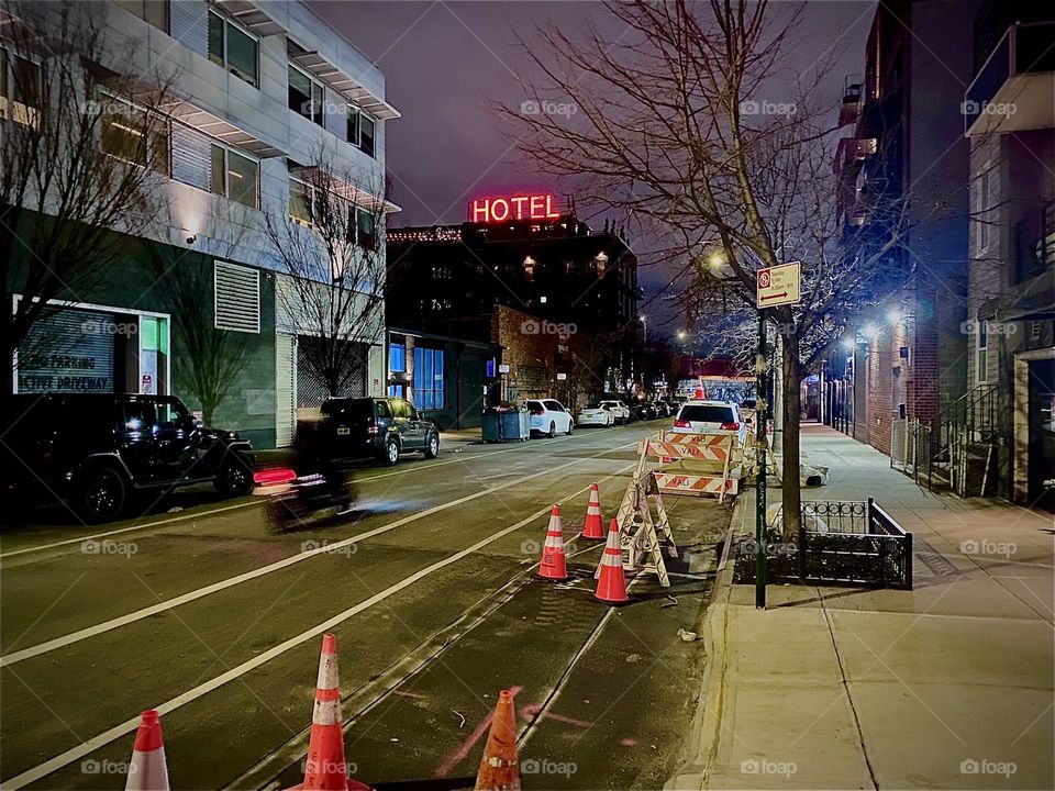 The „BOXHOUSE Hotel“ seen from „Boyhouse St“ walking towards the „Pulaski Bridge“ with a large red „HOTEL“ sign lit up for all to see. 2023. Hypnotic Productions