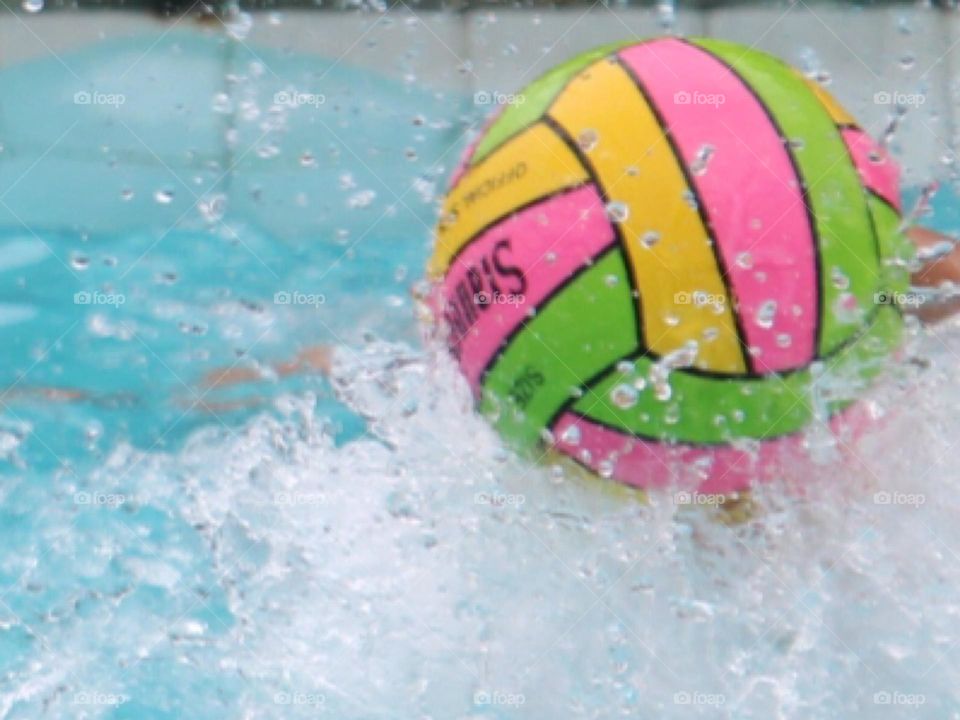 Waterpolo ball moving rapidly in waterpolo game, magnificent splash 