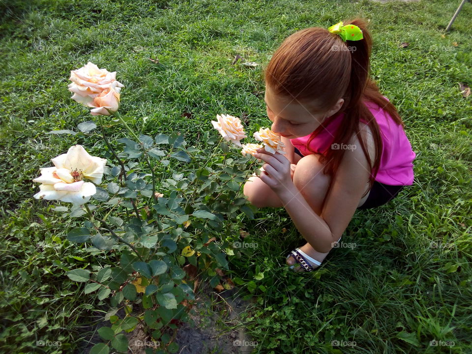 Beautiful redhead girl and roses