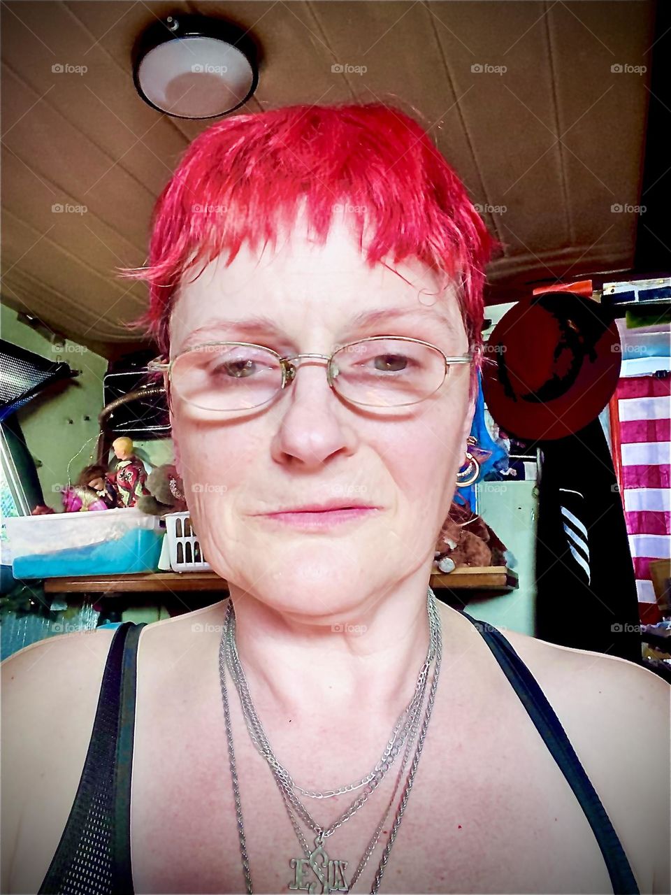 A portrait photograph of myself, „Petra Schiller“ standing by the window of our boat, the „Salvation“, a 28 foot „Luhrs cabin cruiser“ in the „East River“ at „Newtown Creek“ by the waterfront of the „East River“. 2022. Hypnotic Productions