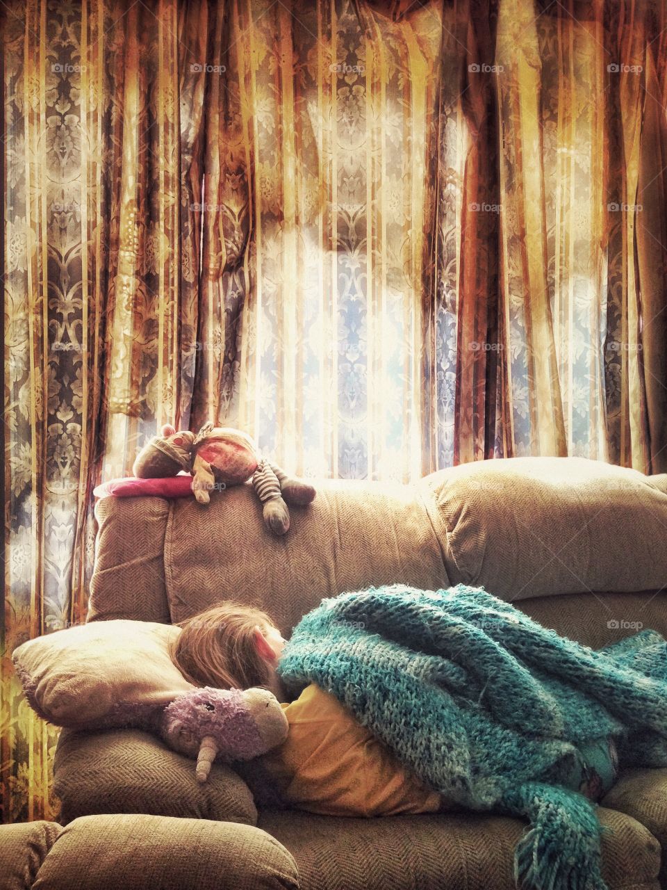 Morning Slumber.

Young girl sleeping on a couch with morning light shining through patterned curtains.