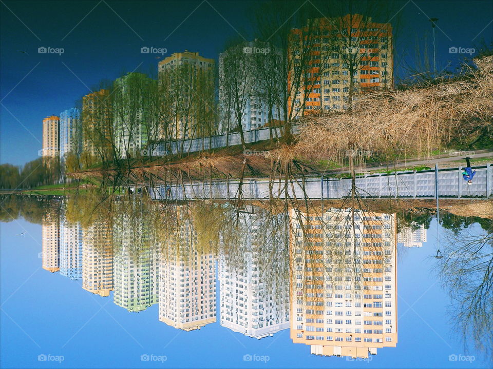 mirror reflection of residential buildings in the lake