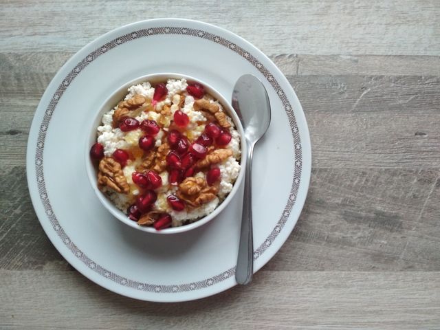 Healthy breakfast fresh cow cheese with nuts and honey.