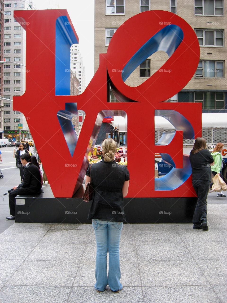  A woman contemplating what others no longer seem to realize it art. Famous ‘LOVE’ sculpture in Manhattan square.