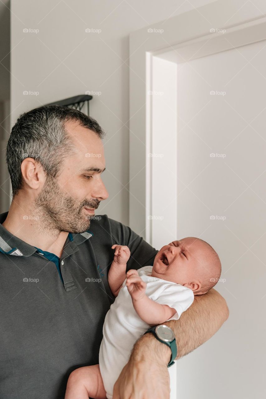 Dad holding his baby son