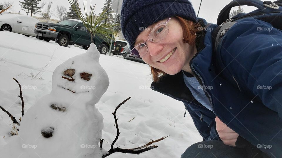 Self Portrait. Red head with snow man in snow