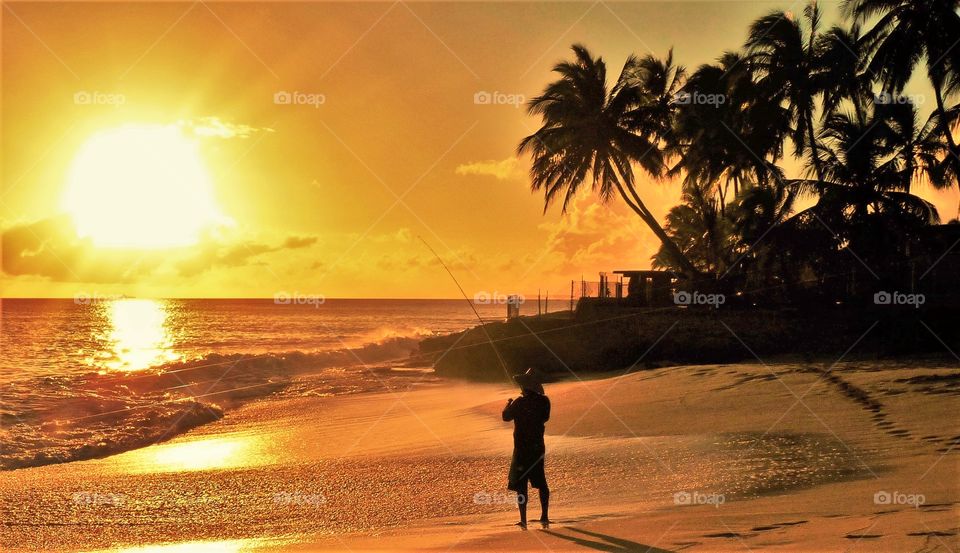 Man fishing at sunset in Hawaii