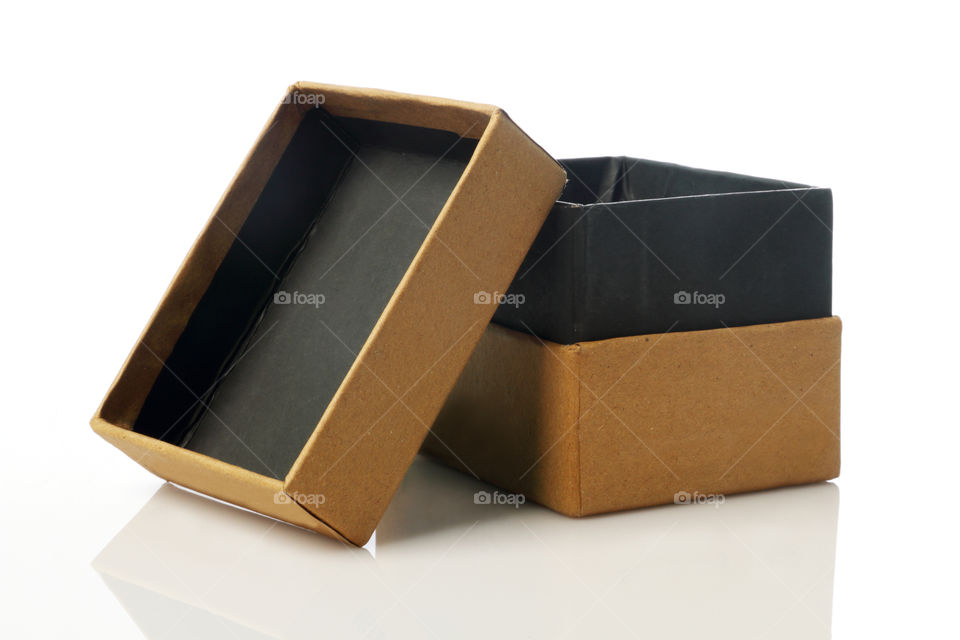 Cardboard box on white reflective background